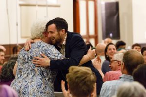 Oral history contributor Aileen Thomas hugs Nate after the premiere of State.